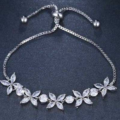  The Rhinestone Flower Bracelet is a sparkling flower bracelet that is a dazzling addition to any outfit. Perfect for any bride or woman who is looking to add a touch of sparkle to their special day or night! It features a slide bead, and flower petal rhinestones! 