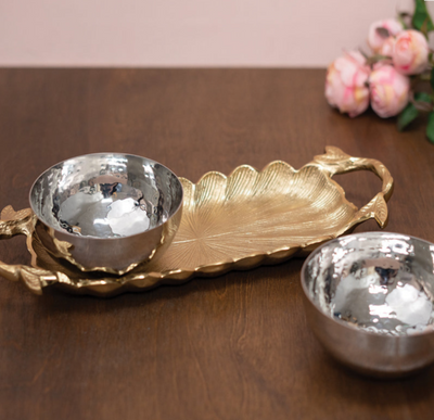 This Gold Gilded Tray & Silver Dip Bowls is an elegant serving must have for all your party relishes and dips! The beautiful leaf and twig design adds perfect details. Pair this set with our other matching serving pieces for a gorgeous party table! 