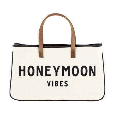 The Honeymoon Vibes Bag is the way to go when wanting to escape in style! The genuine leather handles are stitched to a heavyweight canvas that provides a clean modern look! This tote is offered in a simplistic design that you can carry anywhere; the perfect getaway bag!