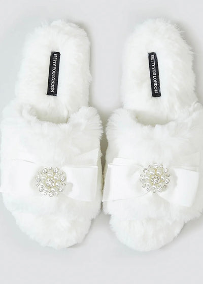 The Cream Rhinestone Pearl Slides is a slipper for every season! This elegant open-toe style features a bow adorned with rhinestones and pearls for extra glam!  One of our best sellers, the crushed velvet padded footbed gives long-lasting wearability and irresistible comfort.  Great gift for those brides to be! Pair with our cream satin robe with feather cuffs for perfect glam pics!