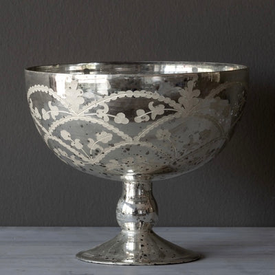 The graceful shape of this footed mercury glass garland compote paired with the stylized leaf and garland design of the etching make for a statement piece on any table.