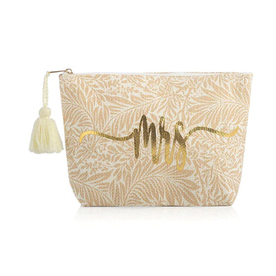 The “Mrs.” Posy Pouch in Natural is perfect for the bride to be! The “Mrs.” Posy Pouch gives this classic silhouette a bridal update. This pouch features an abstract floral print in shades of tan and white, with “Mrs” written in a whimsical gold foil cursive font. It is a zip pouch accented with a cream tassel attached. Perfect for storing the brides essentials on her big day or honeymoon!  Pair with our matching tote!