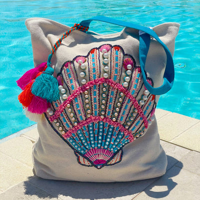 This beaded shell beach bag with tassels makes a perfect tote for your tropical vacay!  Looks super cute on for a day at the pool with the detailed hand beadwork. The bag comes with an oversized tassel to add a touch of fun!  Perfect gift for any bride to take on her honeymoon!
