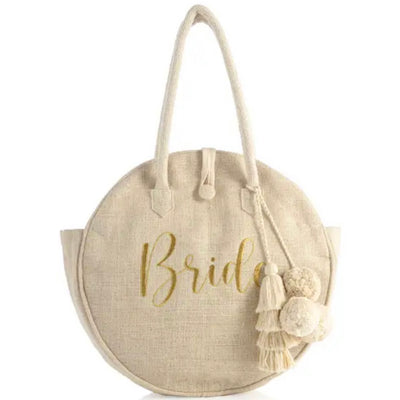 The Bride Tote in Natural with Tassels is the super stylish way to keep all of your wedding essentials together!  This bag makes a great bridal shower or engagement party gift for the bride to be!  ”Bride” printed in gold foil.