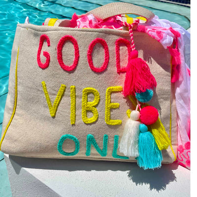 The “Good Vibes Only” Beach Tote Bag is super cute and so fun! It’s neon details and colorful tassels are sure to catch eyes! You need this on your next beach trip, bachelorette weekend, or honeymoon!