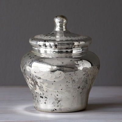 Modeled after vintage urns, this lustrous mercury glass lidded urn has an etched scroll pattern feature and antiqued finish.  Item Dimensions: 5"L x 5"W x 6"H